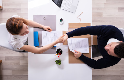 man and woman shakehands | hiring an HOA management company