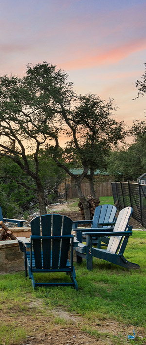 chairs around firepit | hoa management in drippings springs